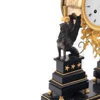An Empire Ormolu, Black Granite and Patinated Bronze Mantel Clock