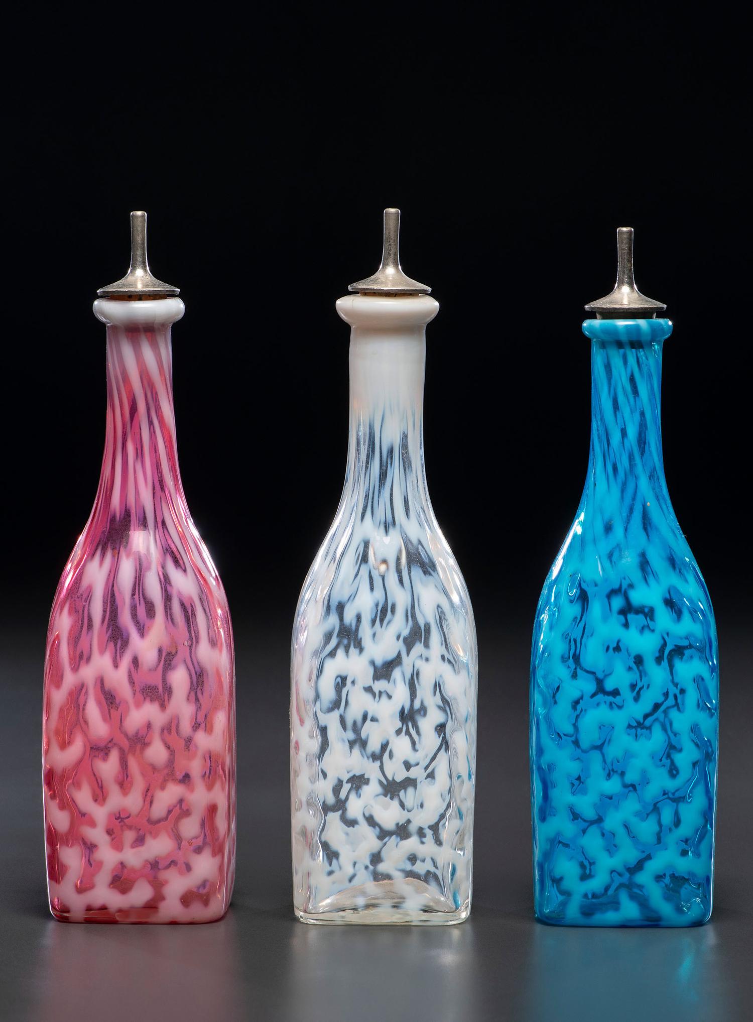 Three Coral Opalescent Glass Barber's Bottles