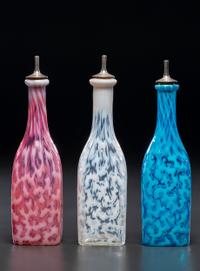 Three Coral Opalescent Glass Barber's Bottles