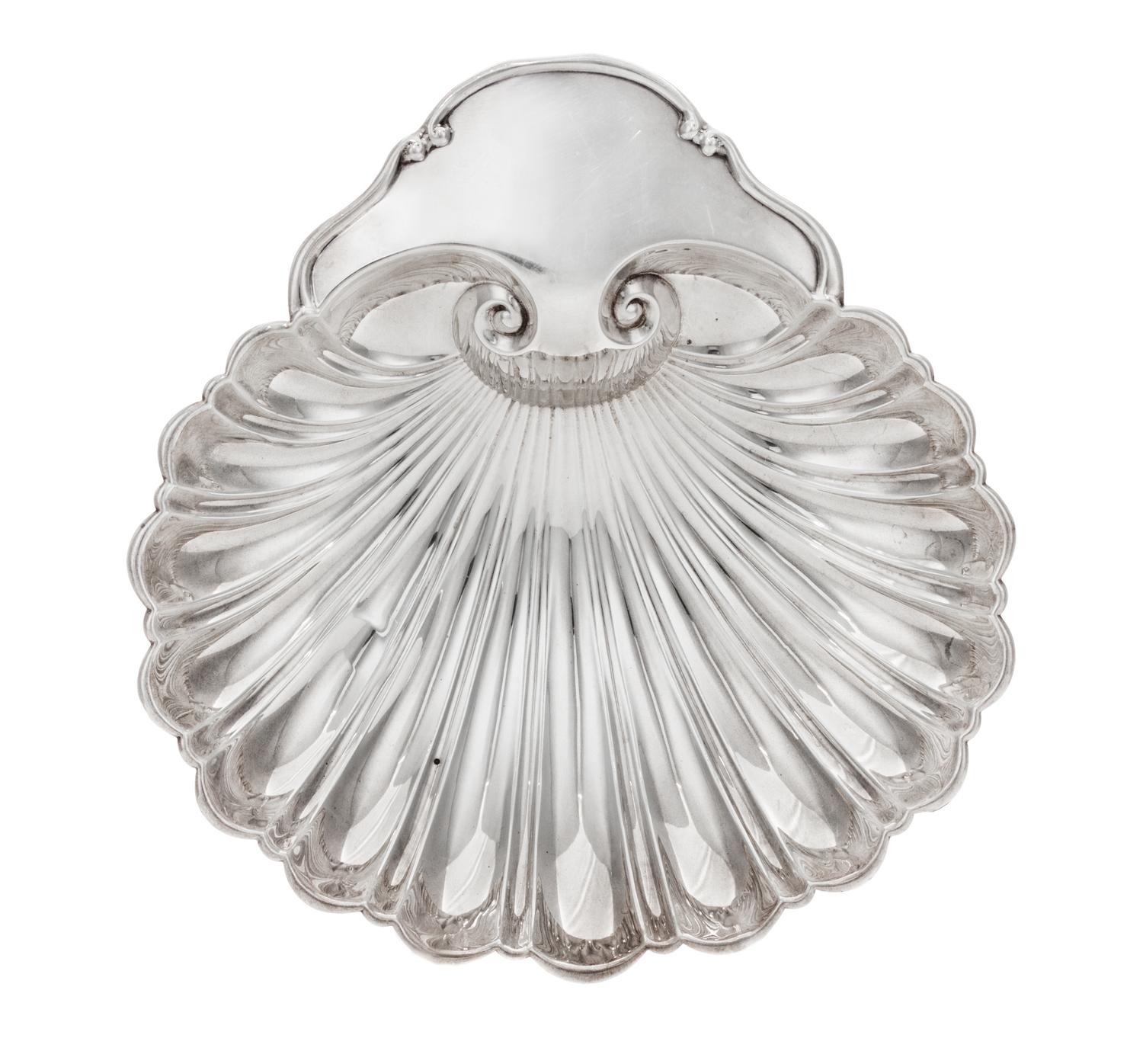 An American Silver Dish, Fisher Silversmiths, Newark, NJ, Mid-20th Century, formed as a shell and raised on three scroll supports.