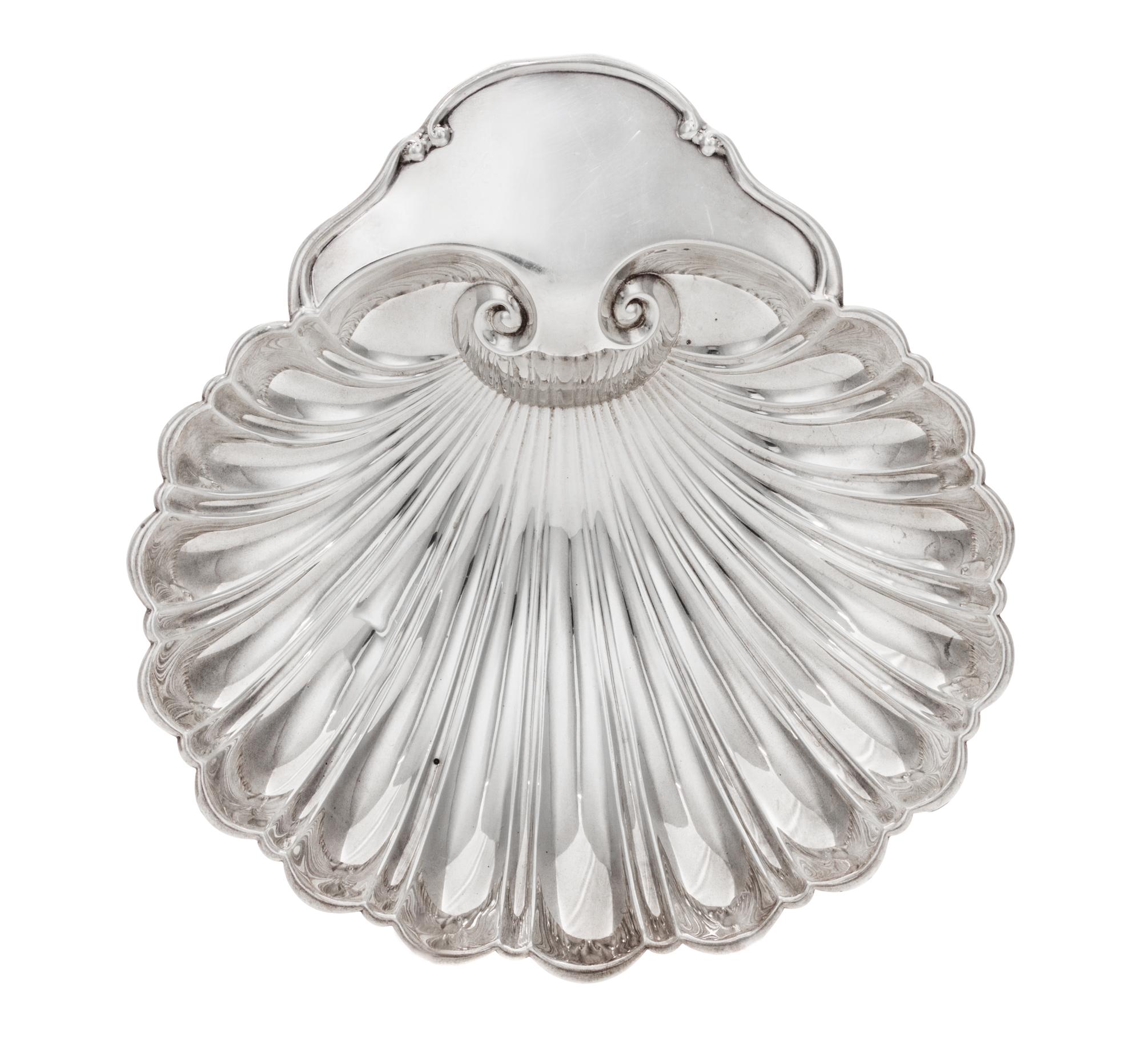 An American Silver Dish, Fisher Silversmiths, Newark, NJ, Mid-20th Century, formed as a shell and raised on three scroll supports.