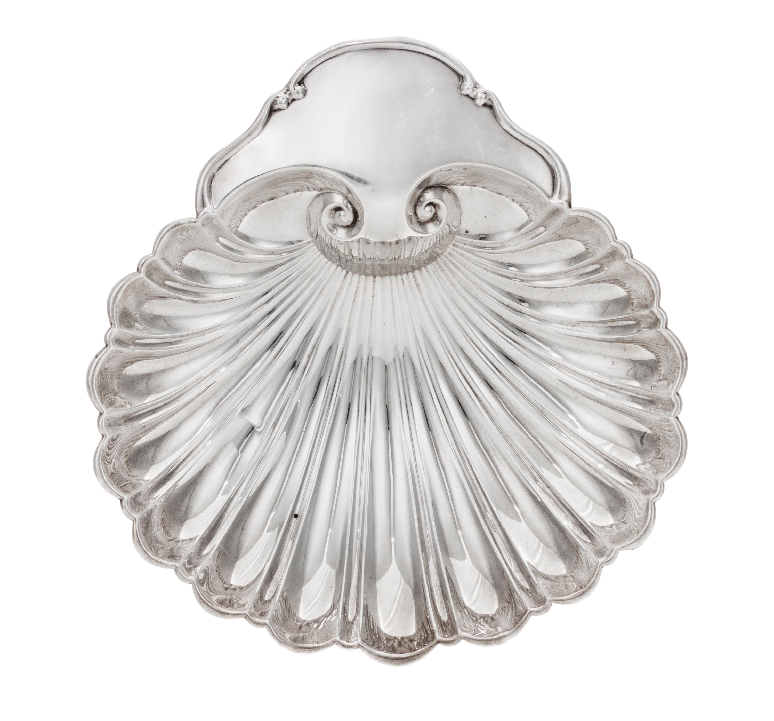 An American Silver Dish, Fisher Silversmiths, Newark, NJ, Mid-20th Century, formed as a shell and raised on three scroll supports.