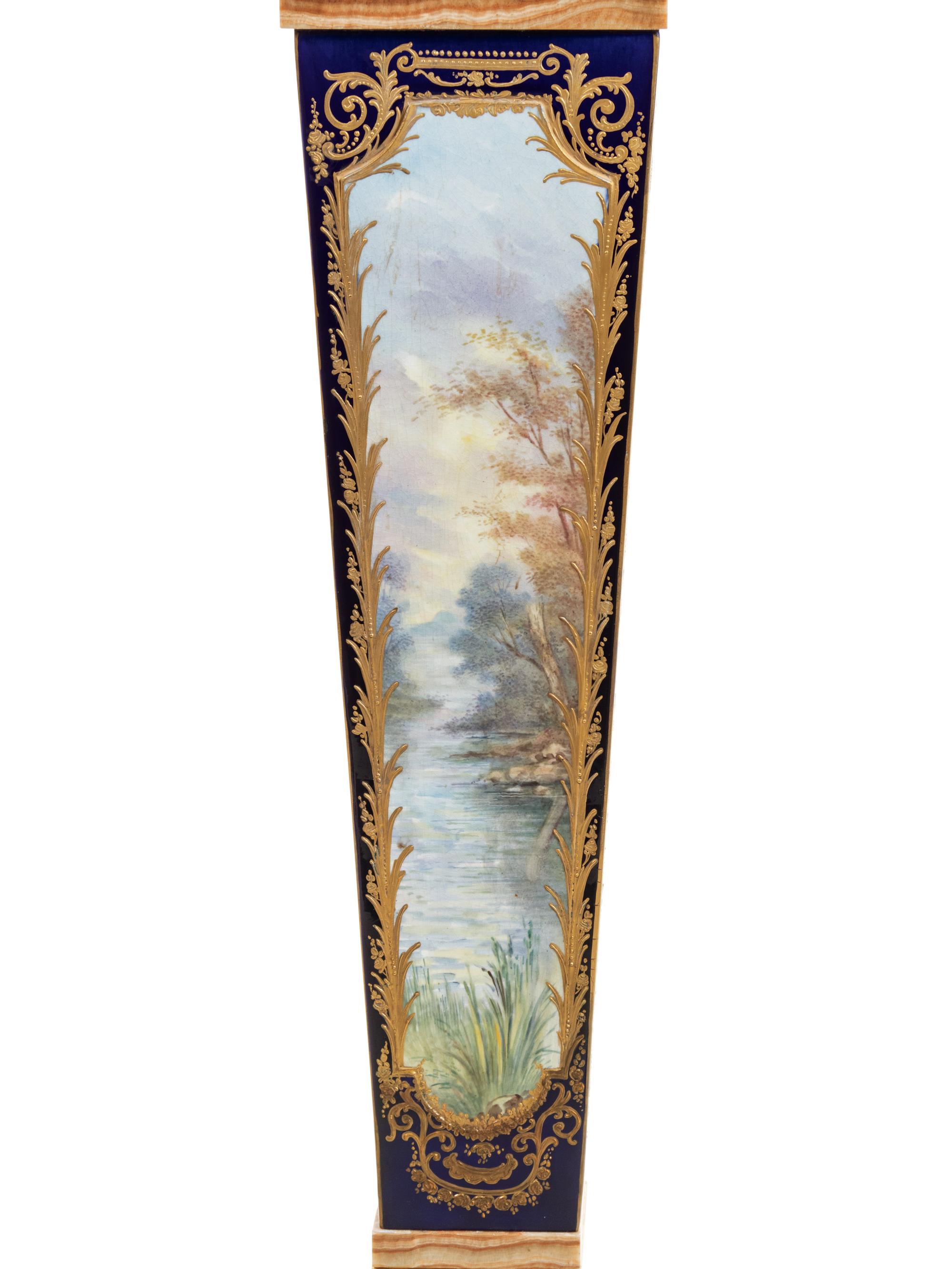 A Pair of Sèvres Style Gilt Bronze Mounted Painted and Parcel Gilt Porcelain and Onyx Pedestals