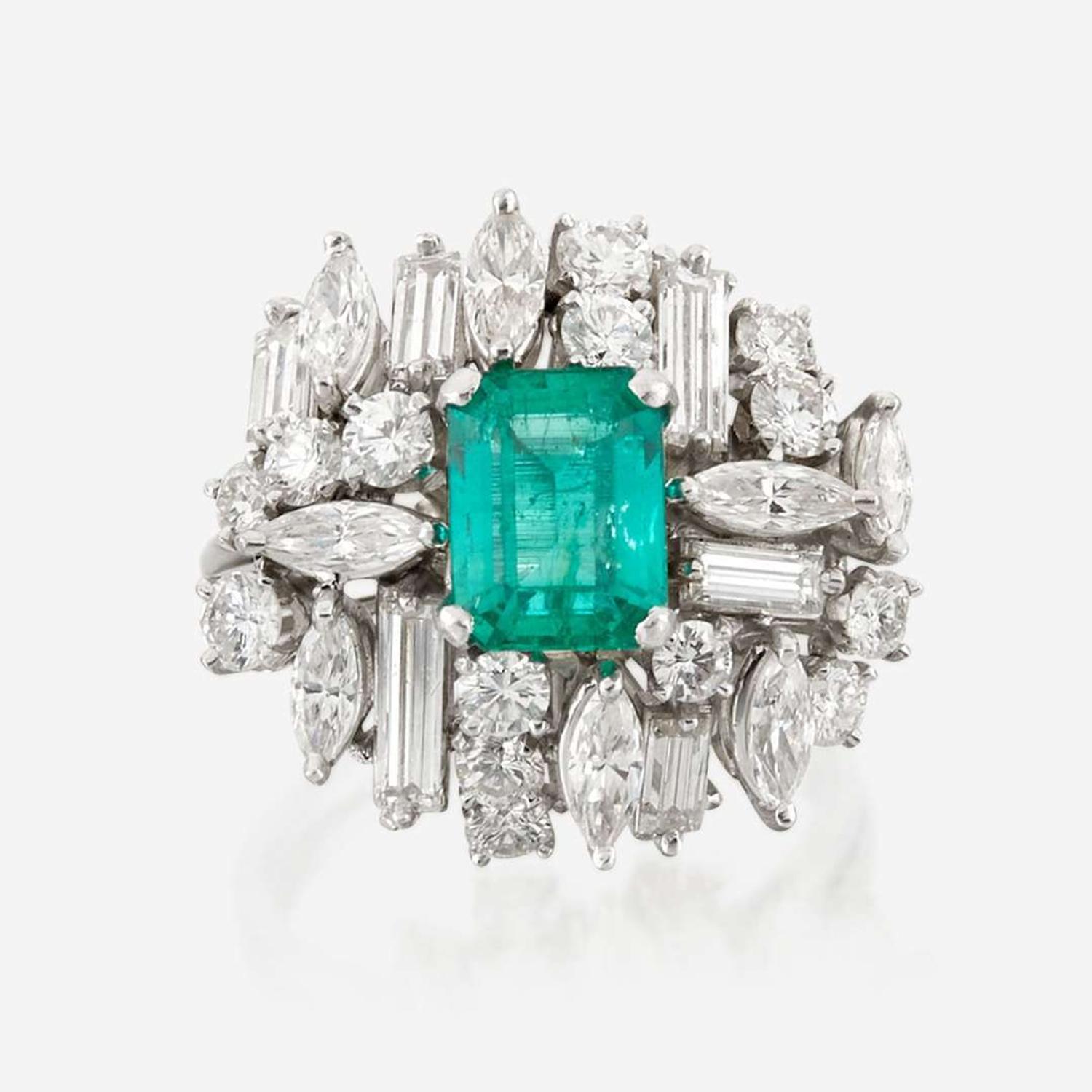 An emerald, diamond, and platinum ring