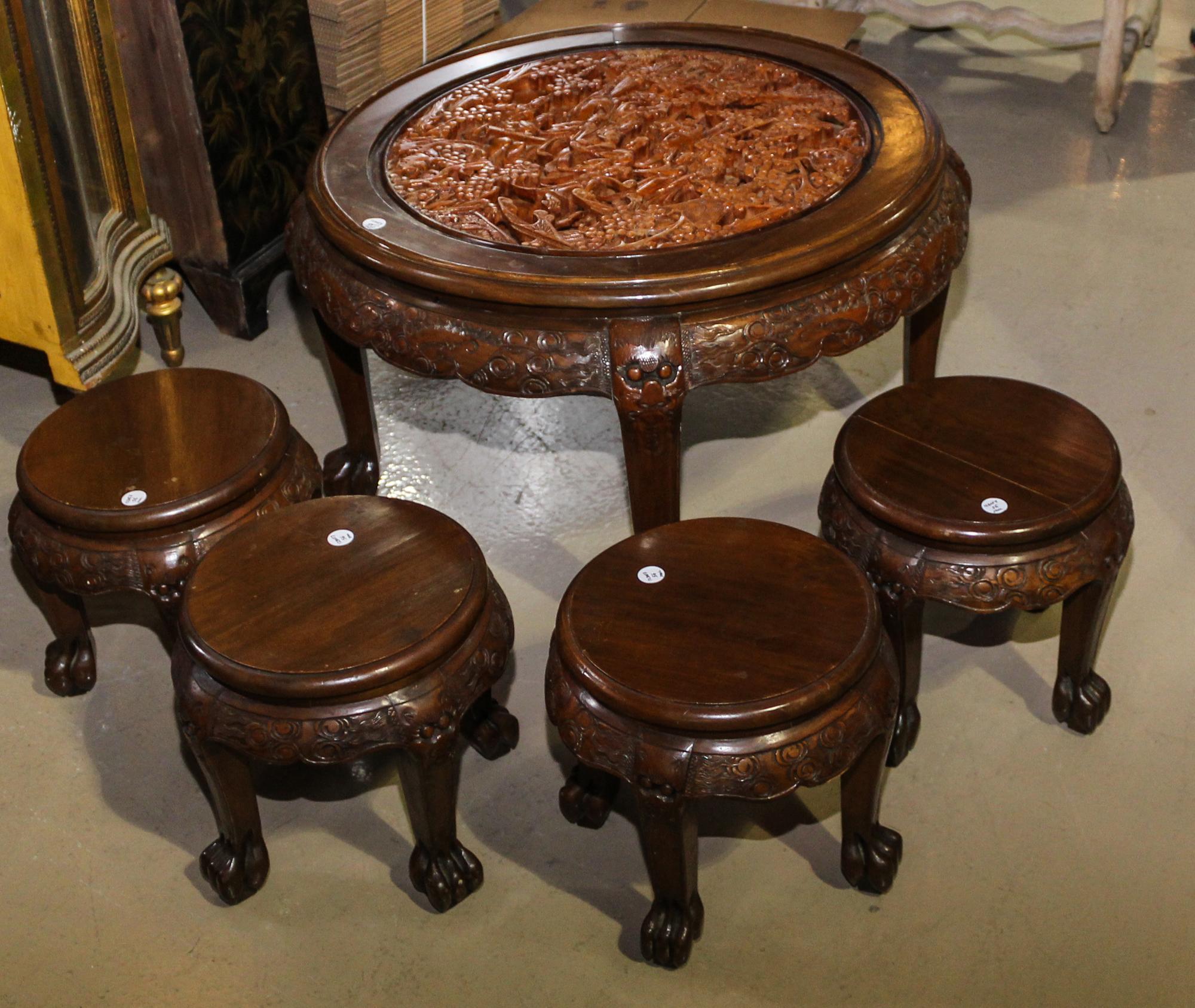 A Chinese Export Carved Wood Low Tea Table. Height 20 x diameter 35 inches.