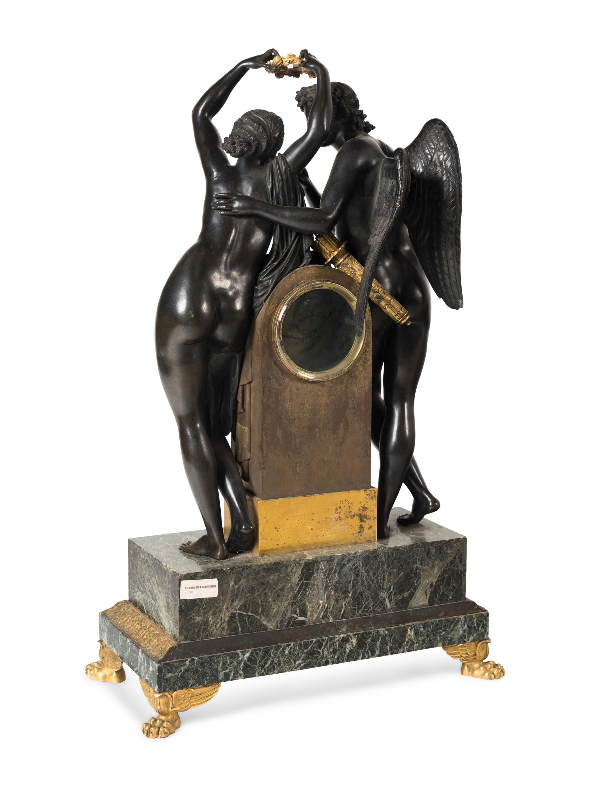 A French Parcel Gilt and Patinated Bronze Figural Mantel Clock