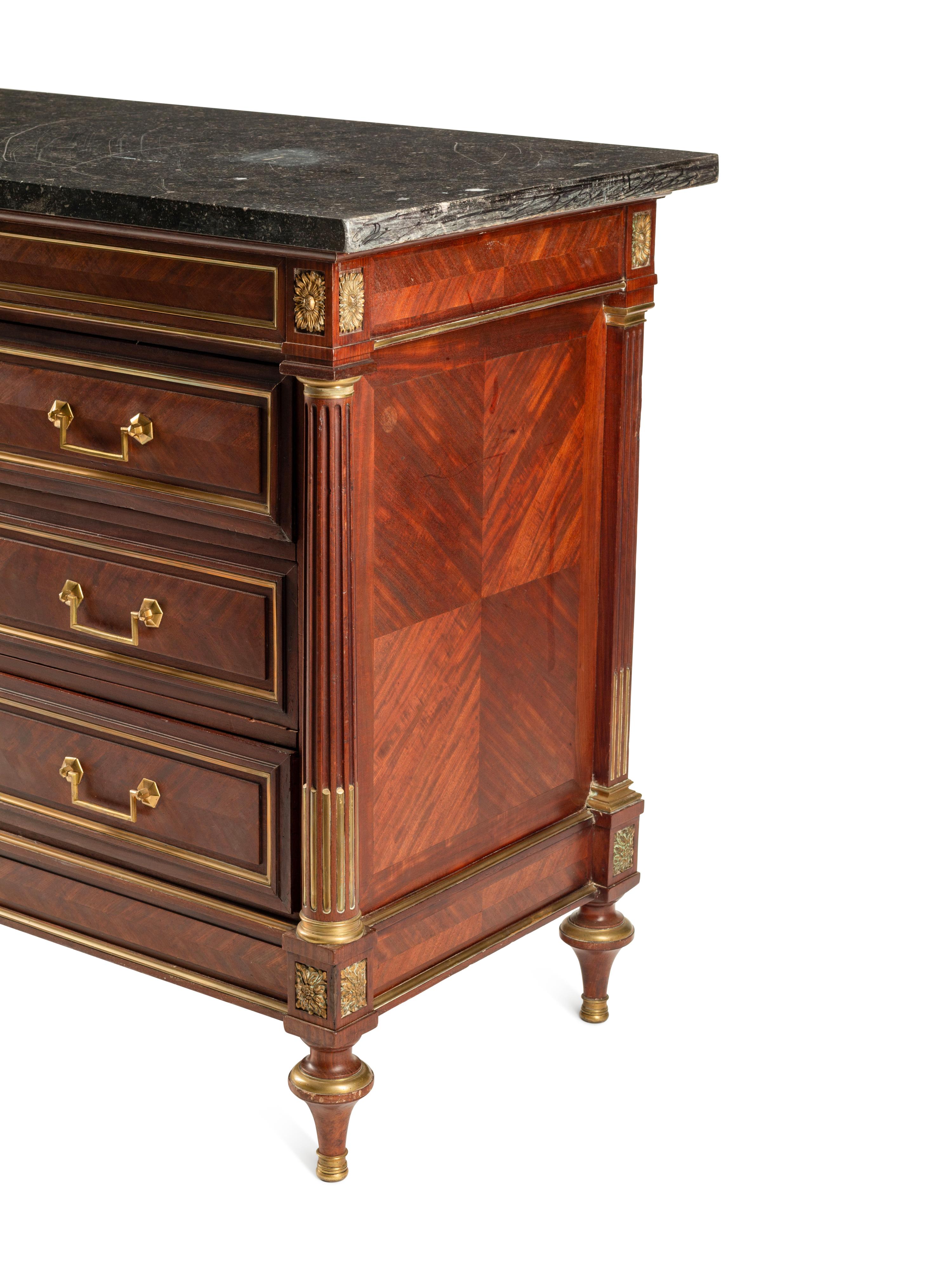A Louis XVI Style Gilt Bronze Mounted Mahogany Marble-Top Commode