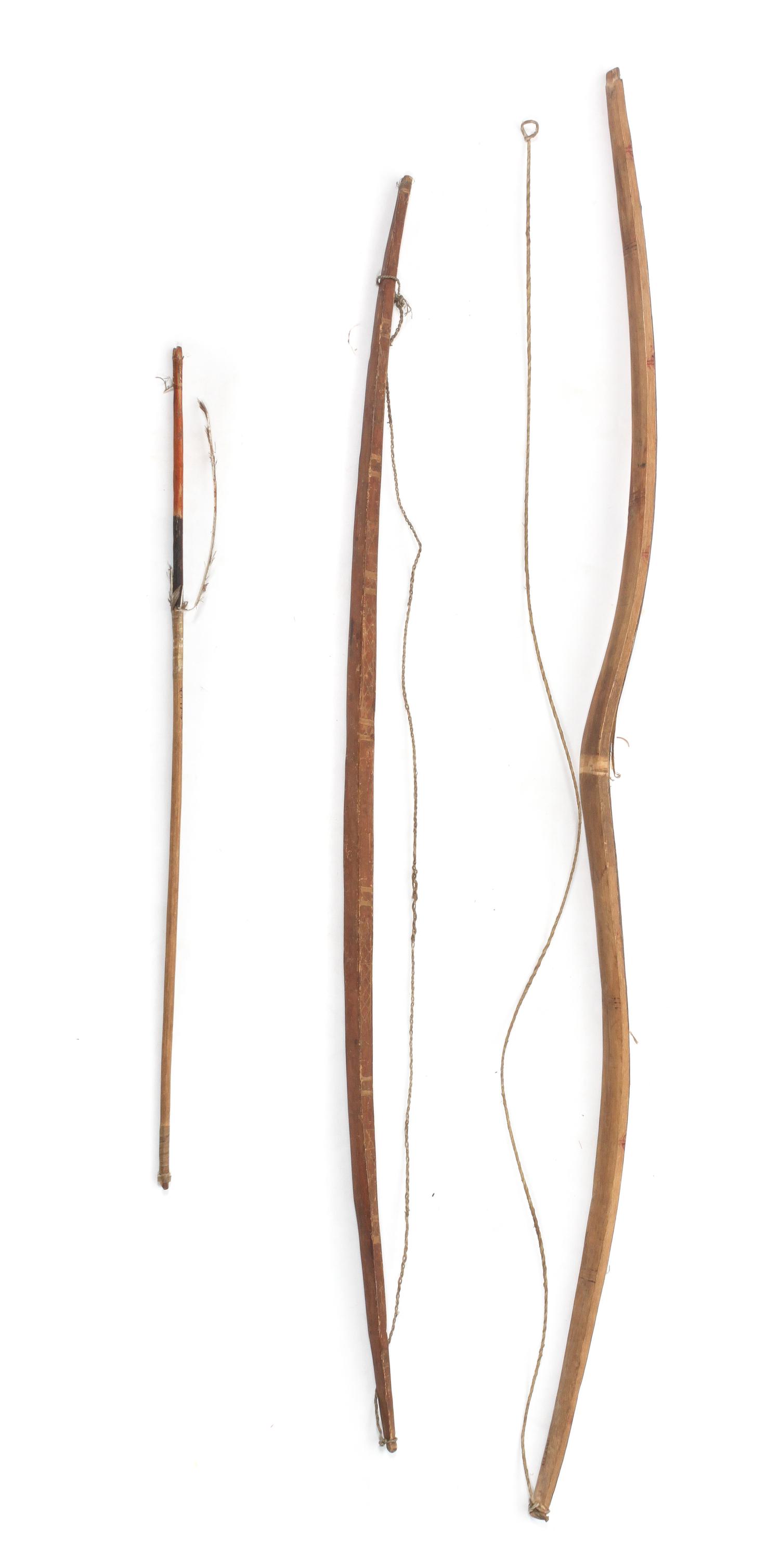 Two Native Bows and an Arrow Length longest bow 46 1/4 inches.