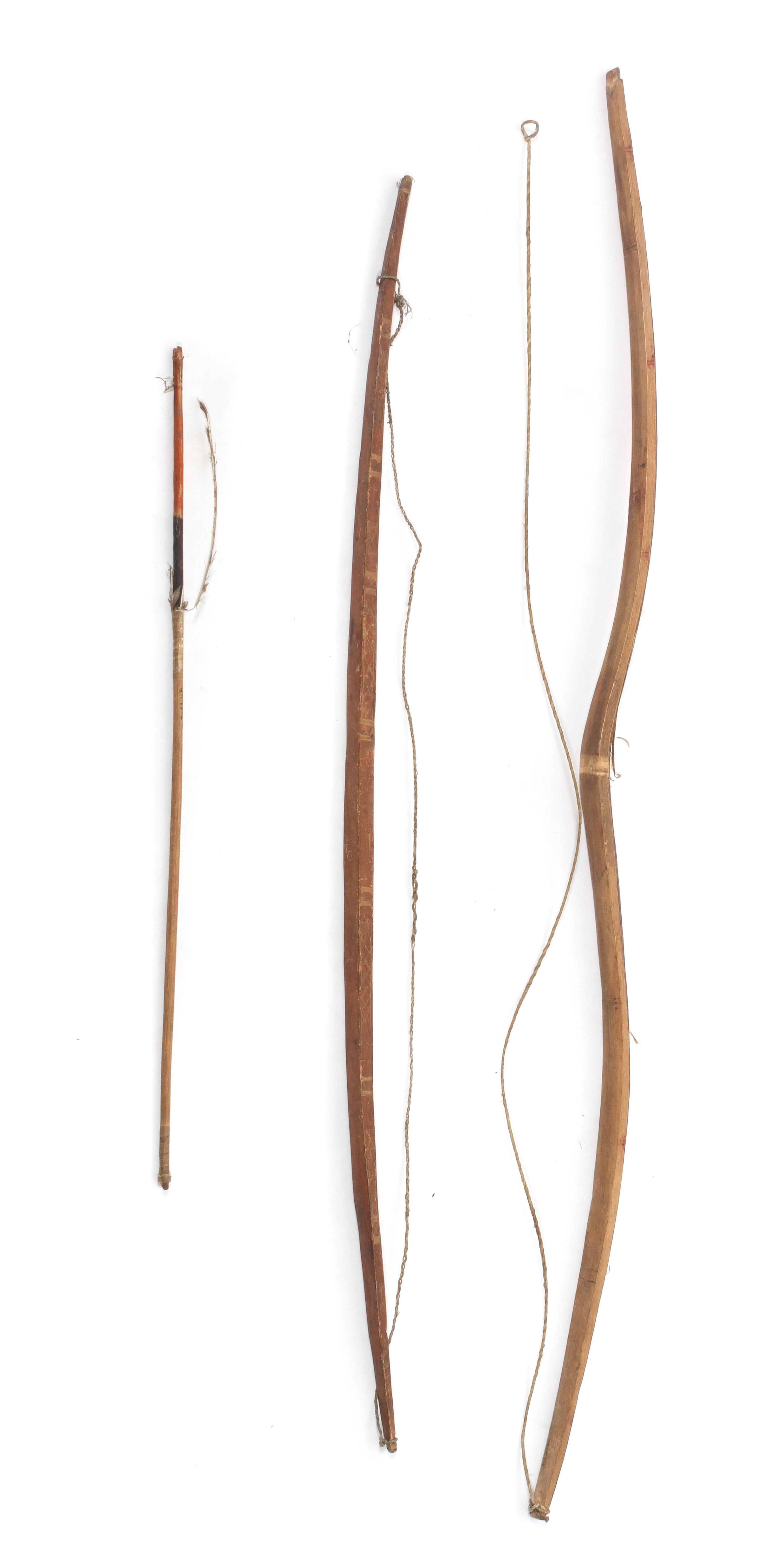 Two Native Bows and an Arrow Length longest bow 46 1/4 inches.