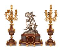 A French Gilt and Silvered Bronze and Rouge Marble Three-Piece Clock Garniture