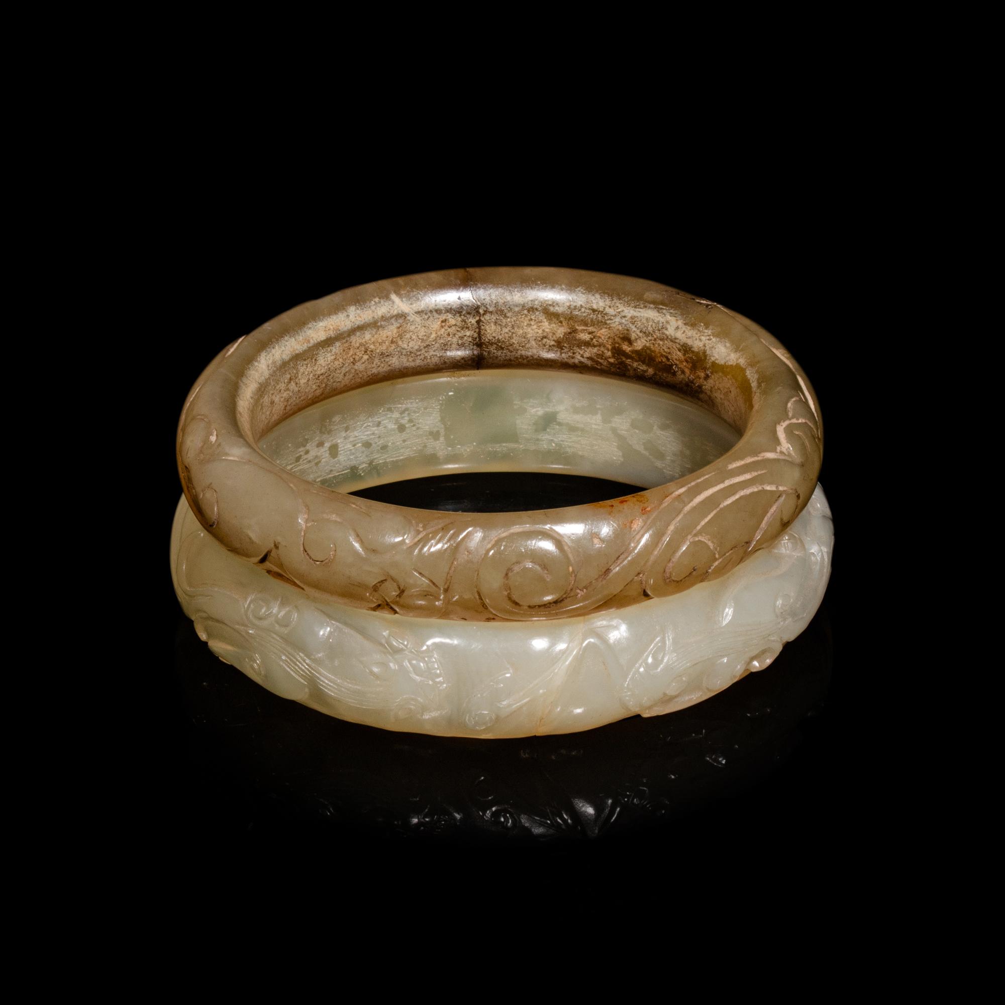 Two Chinese Carved Precious Stone Bangles, Qing Dynasty or Earlier 清或以前 青玉、瑪瑙雕螭龍紋鐲各一