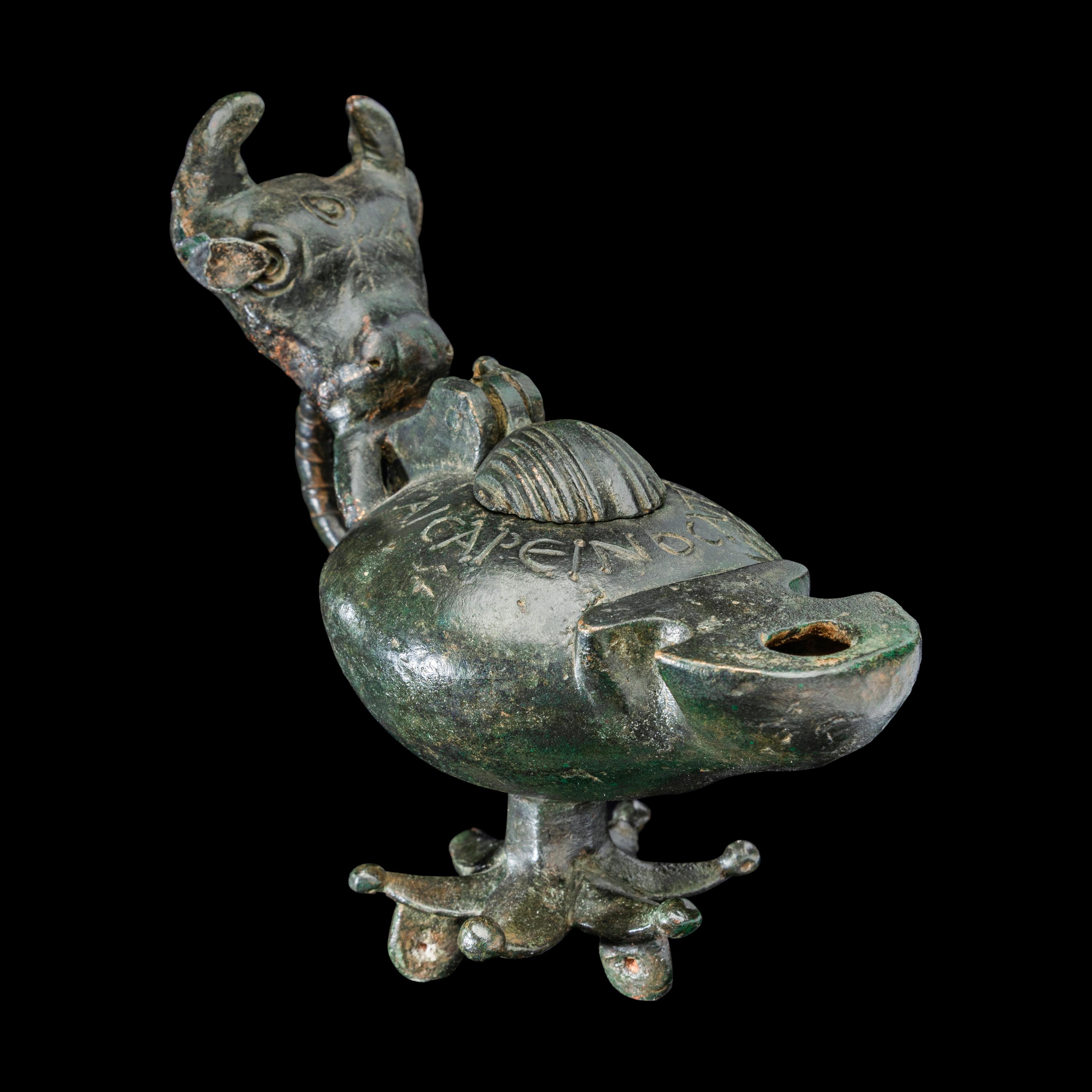 A Late Roman Bronze Lamp with Bull Head Handle and Greek Inscription