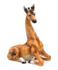 A Glazed Ceramic Model of a Seated Giraffe Height 36 inches. — 20TH CENTURY
