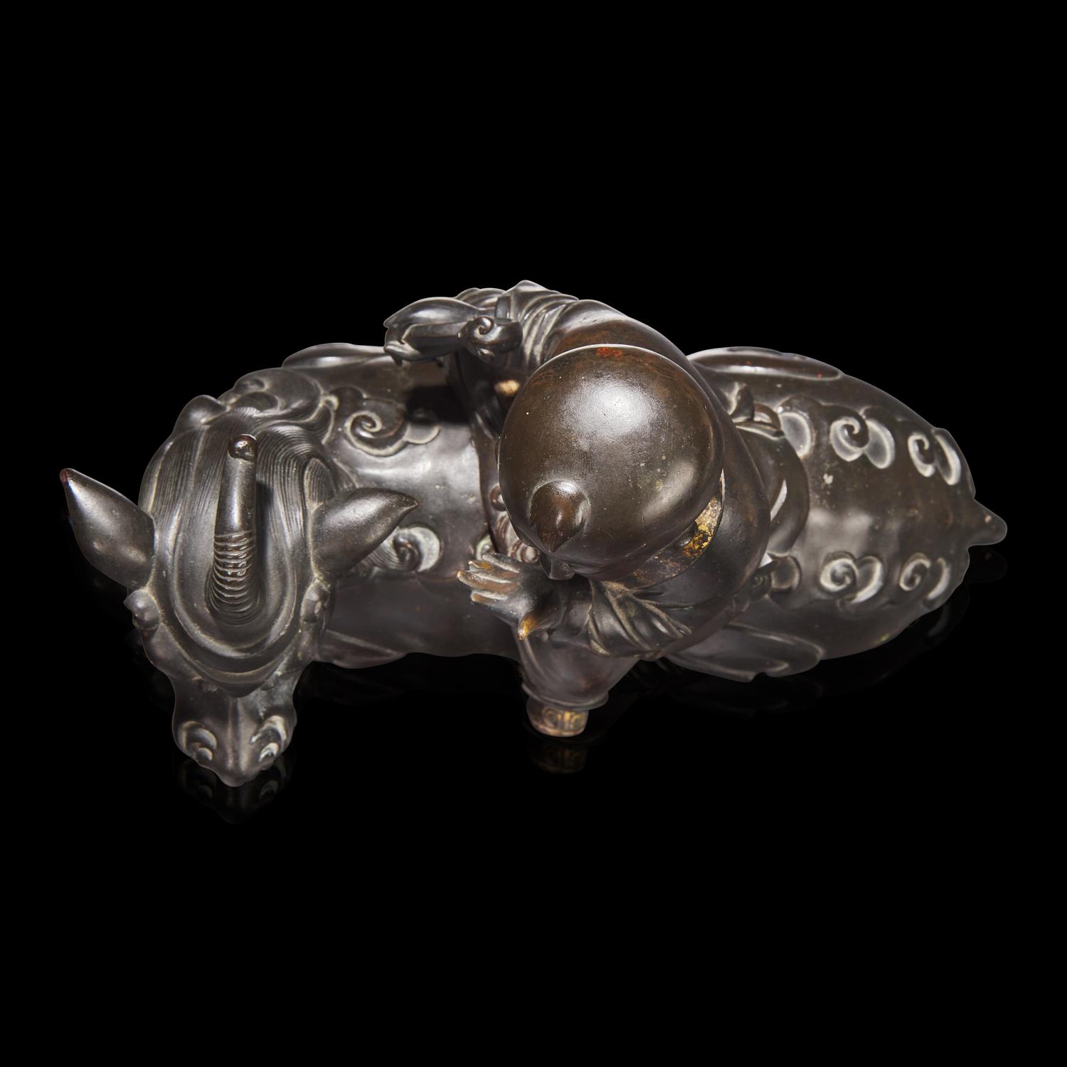 A Chinese Patinated and Parcel-gilt Bronze 'Qilin and Boy' Censer, 17th/18th Century 清早期 銅局部鎏金麒麟童子香薰