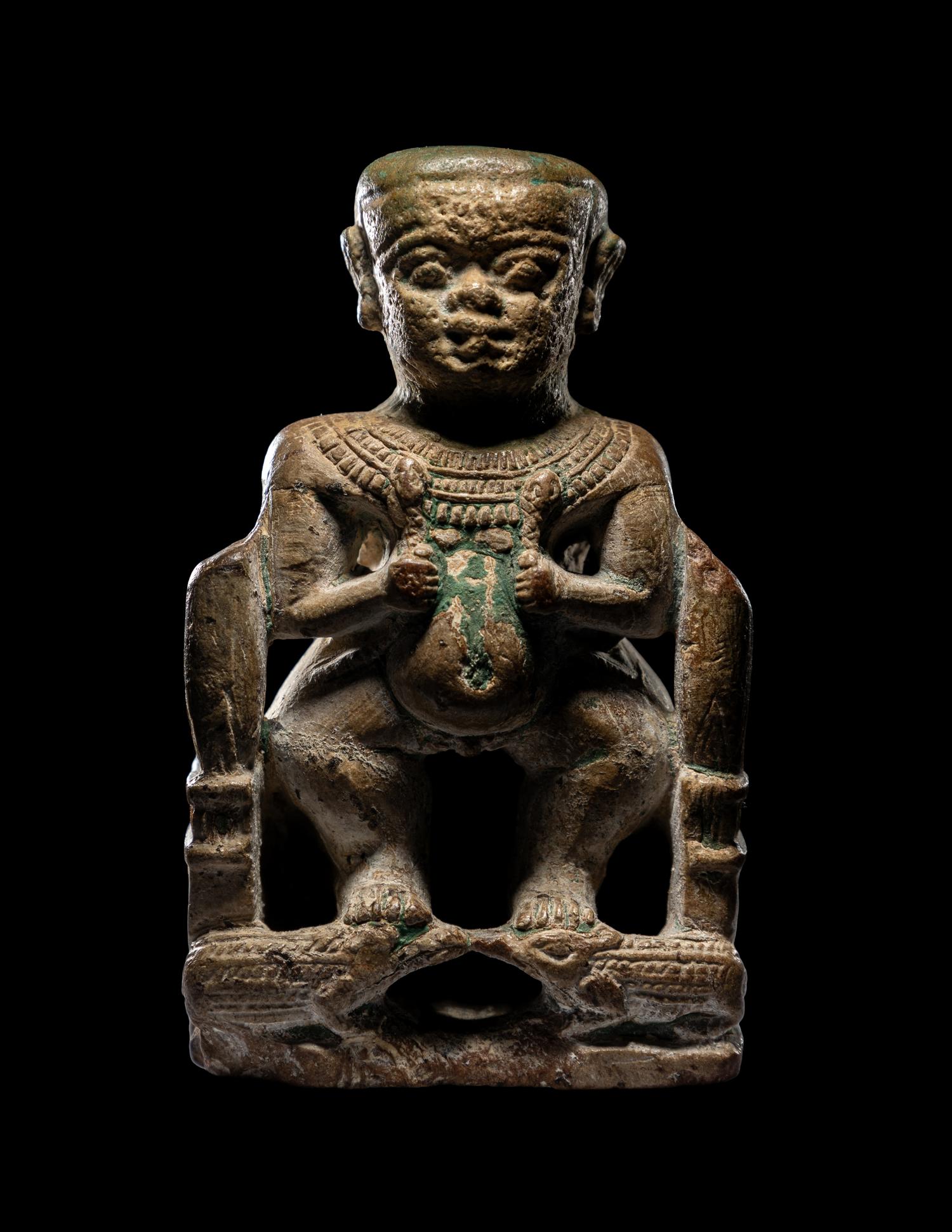 An Egyptian Glazed Steatite Amulet of Pataikos on Crocodiles