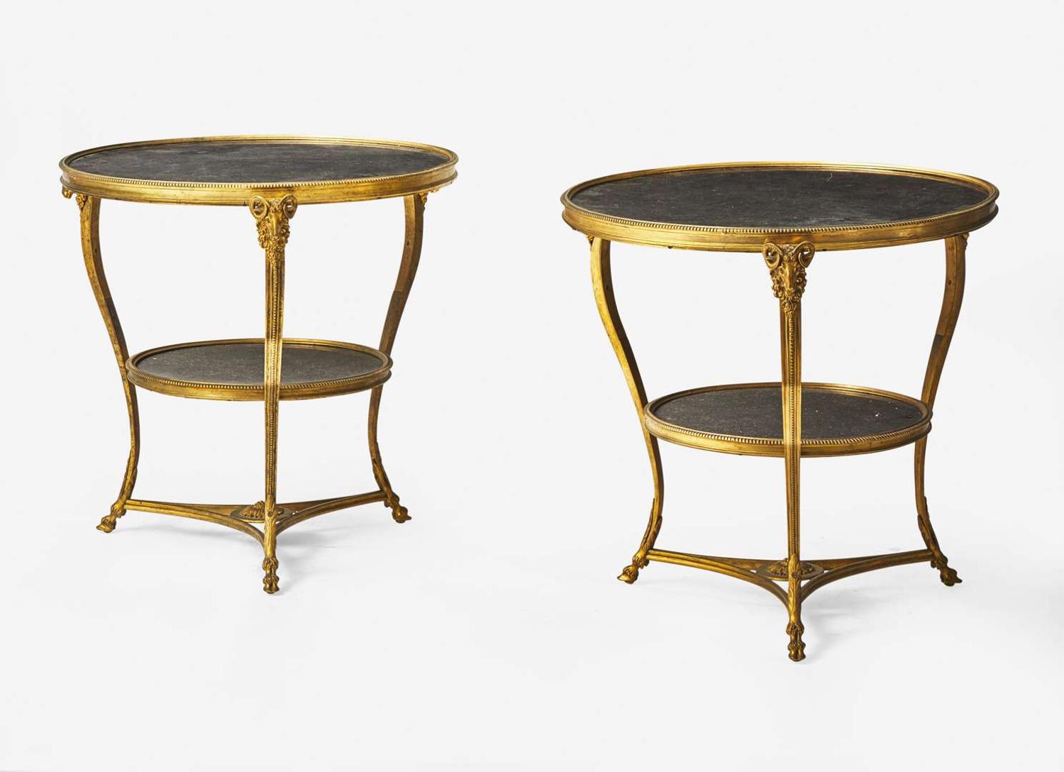 A pair of Louis XVI style gilt bronze and Lumachella nera marble gueridons, 20th century