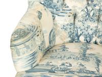A Blue, White and Cream Upholstered Club Chair and Ottoman