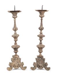 A Pair of Baroque Repoussé Decorated Silvered Metal Pricket Sticks