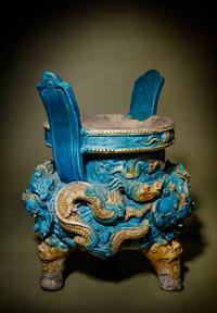 A Turquoise and Ochre Glazed Tileworks Tripod Incense Burner