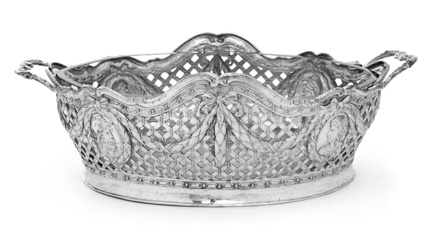A German Silver Basket, Likely Hanau Maker, 19th Century, having an openwork lattice decorated body with foliate and ribbon festooning