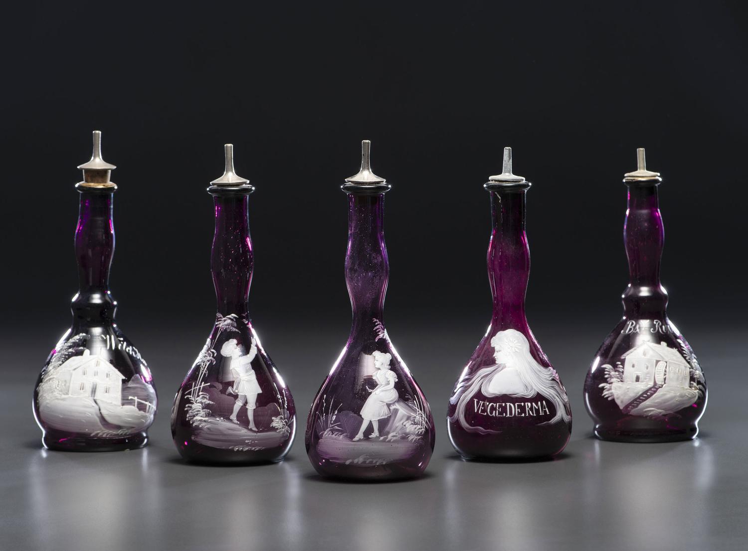 Five 'Mary Gregory' Amethyst Glass Barber Bottles
