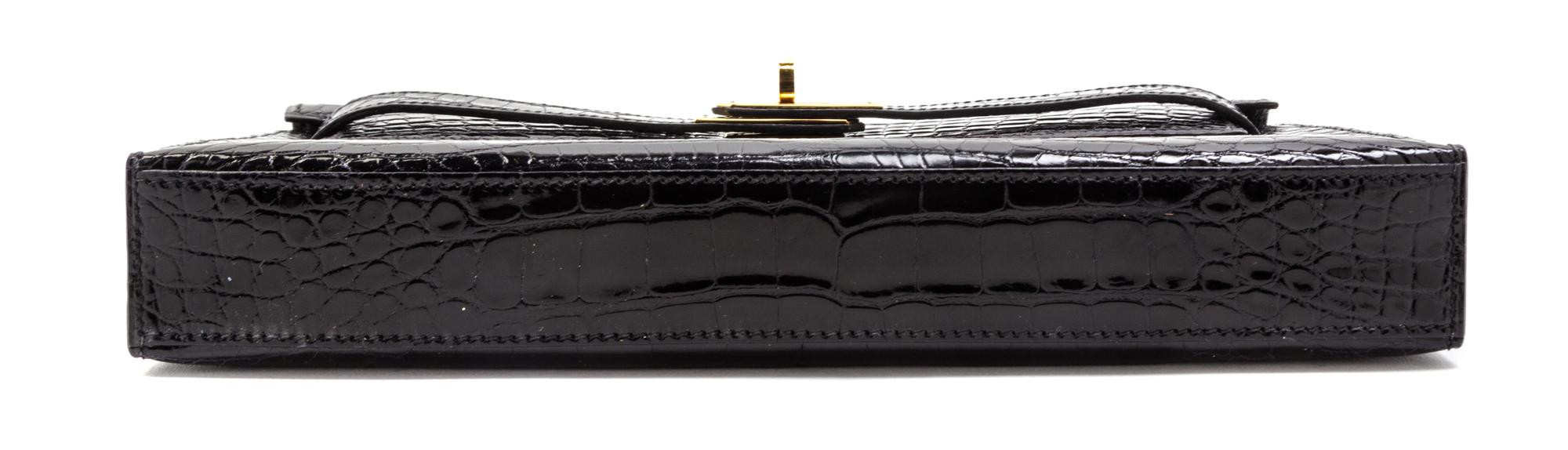 An Hermes Black Shiny Alligator Kelly Clutch Bag, 11 x 6 x 1 1/2 inches.