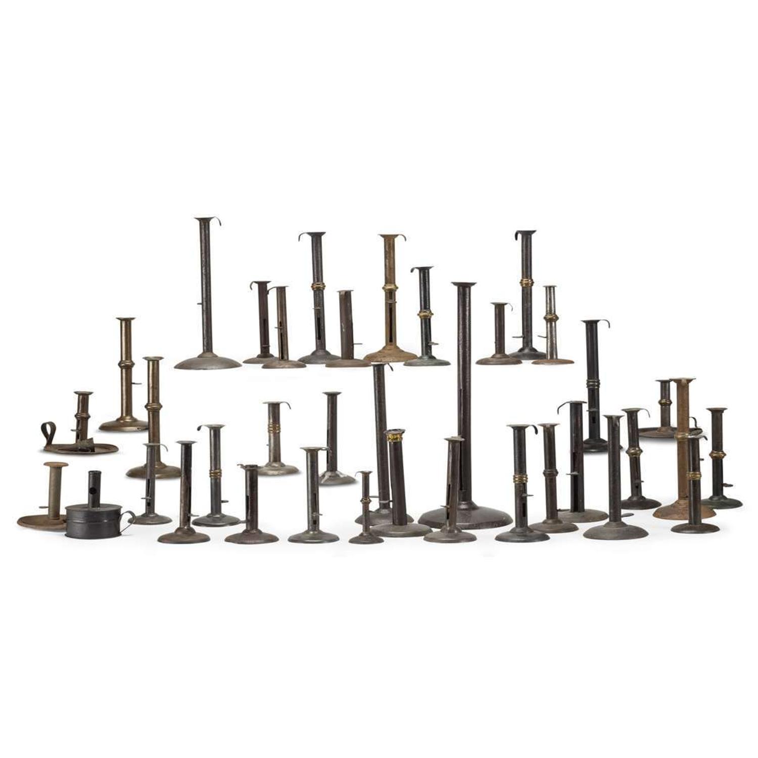 Large collection of thirty-seven iron hogscraper candlesticks 18th/19th century
