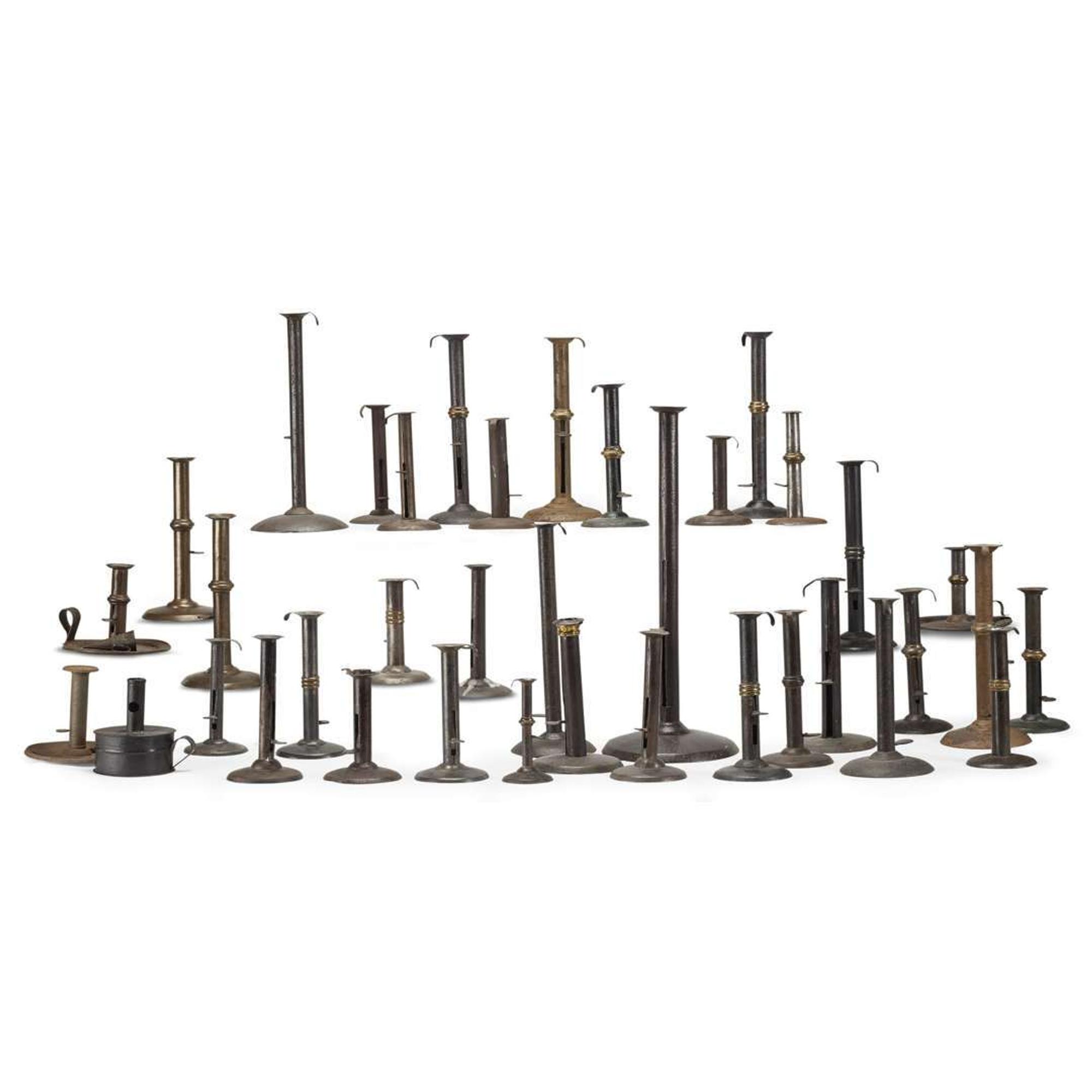 Large collection of thirty-seven iron hogscraper candlesticks 18th/19th century
