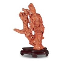 A Japanese carved red coral figure of an Immortal with basket of flowers and a boy on Ho-o bird