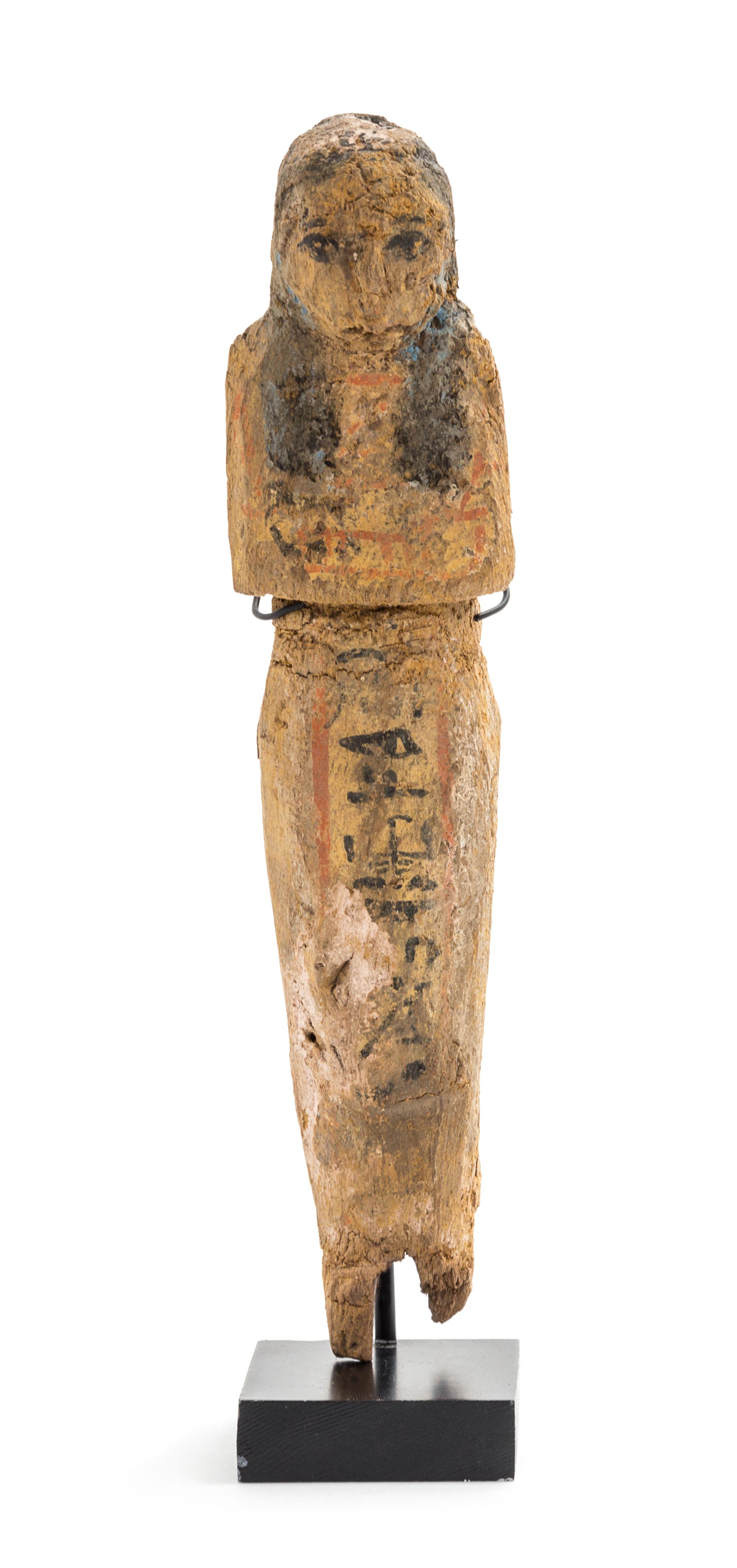 An Egyptian Polychrome Painted Wood Shabti. Height 7 inches.