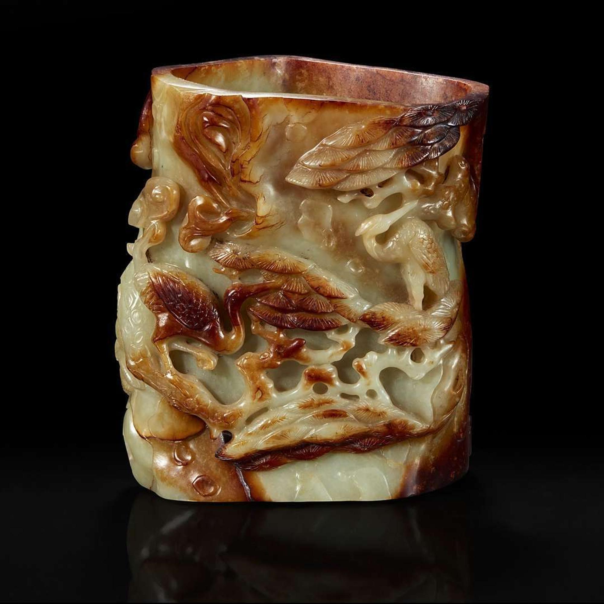 A Chinese carved russet and celadon jade brush holder 青玉笔筒