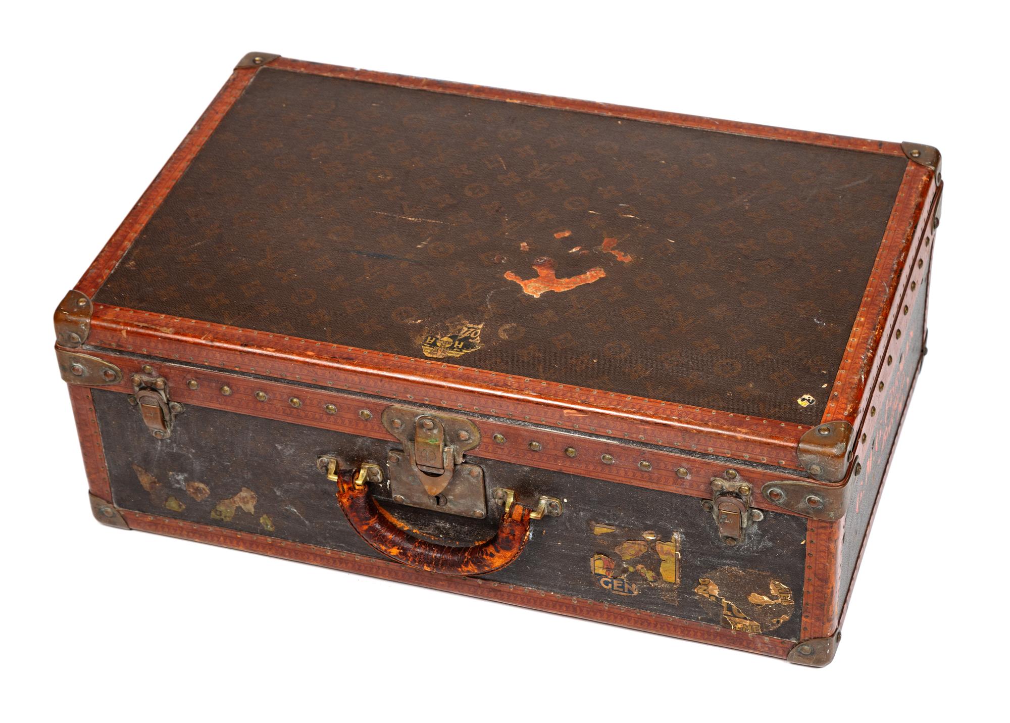 A Louis Vuitton Monogram Canvas Hardsided Suitcase, 15.5" H x 23.75" W x 8" D; Handle drop: 2.25".