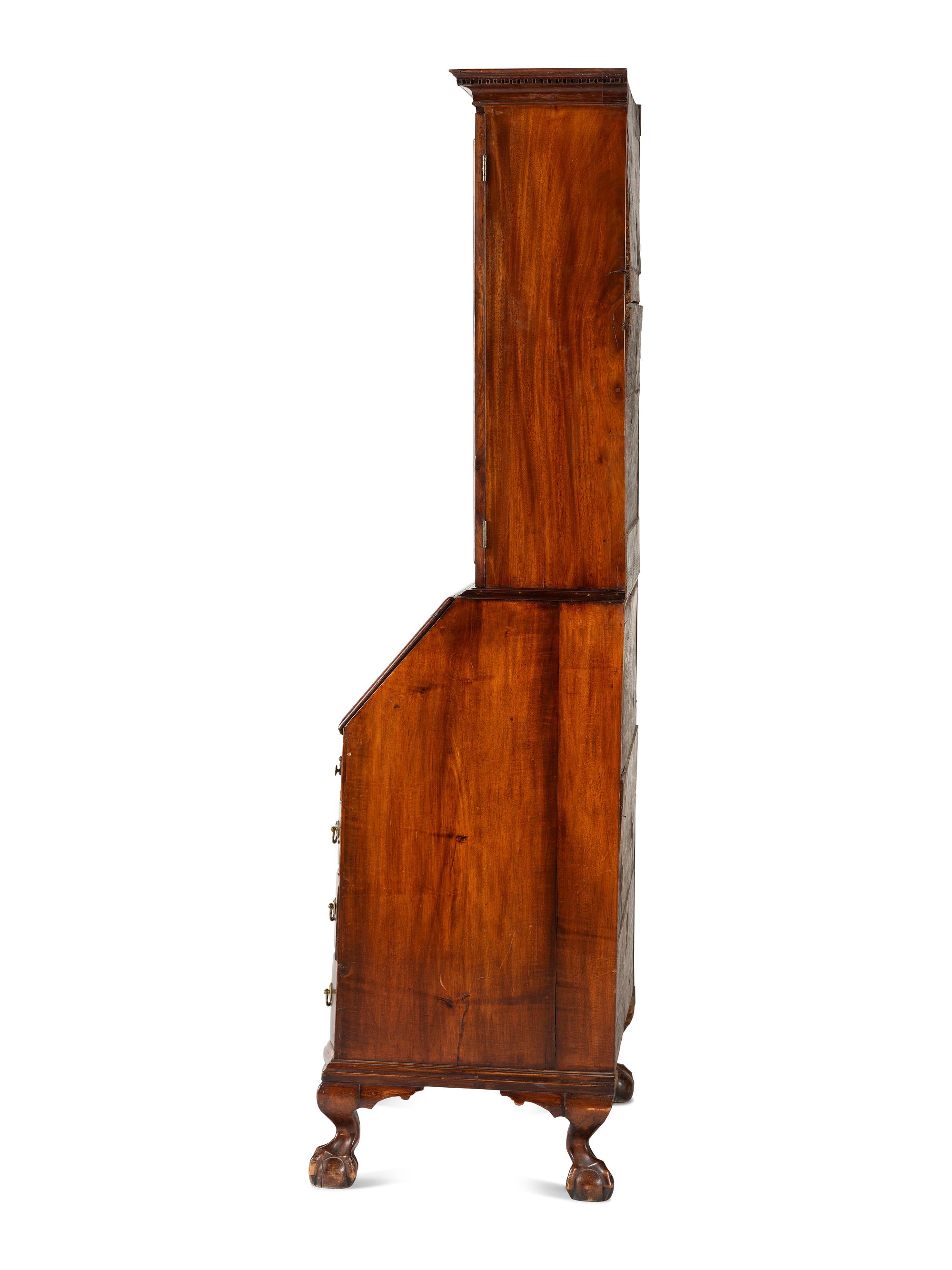 A Chippendale Mahogany and Cherrywood Serpentine Claw-and-Ball Foot Desk-and-Bookcase