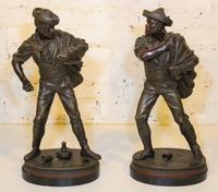 A Pair of Continental Cast Metal Figures. Height 20 3/4 inches.