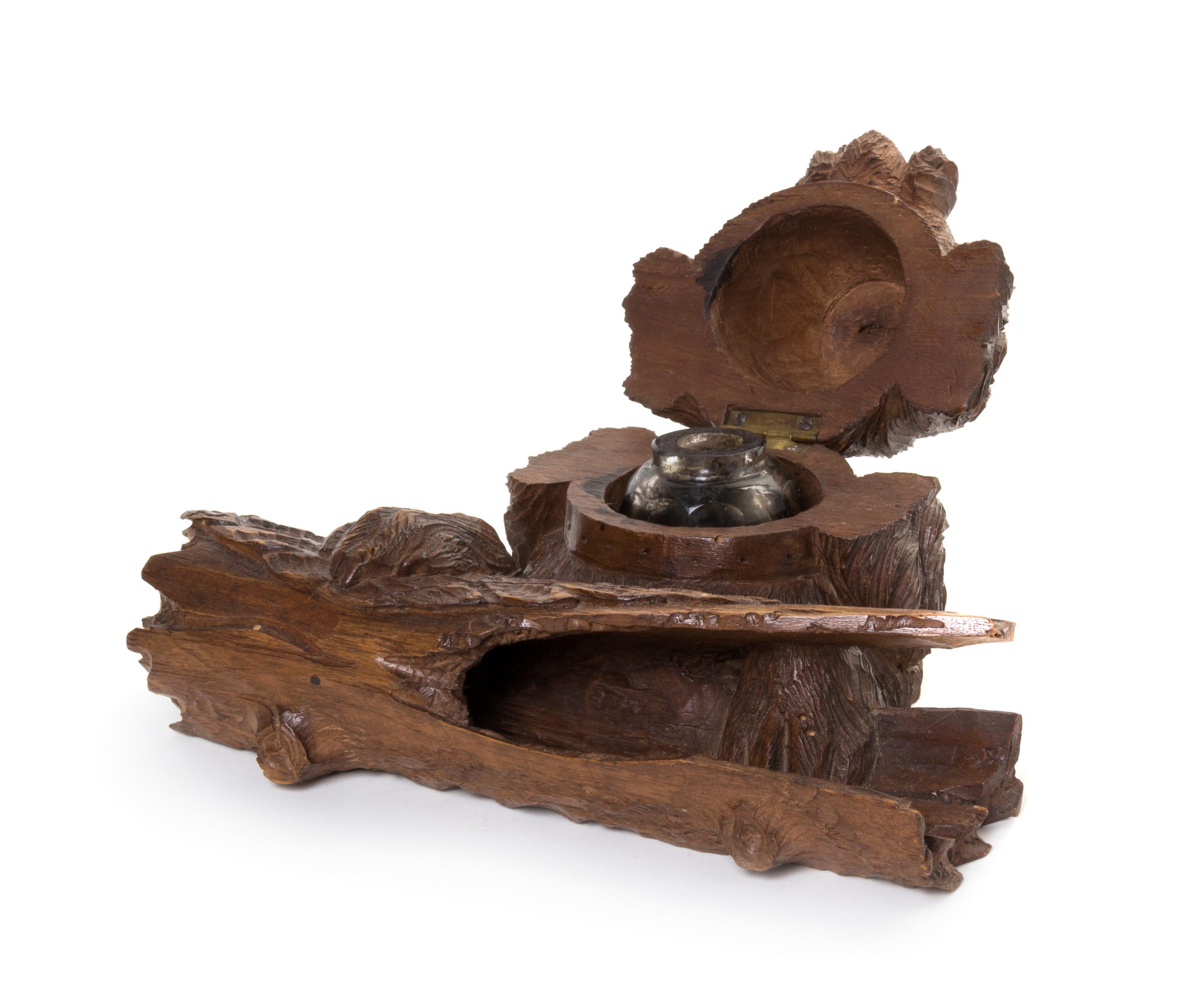 A Black Forest Carved Fruitwood Inkwell, Width 8 1/4 inches.