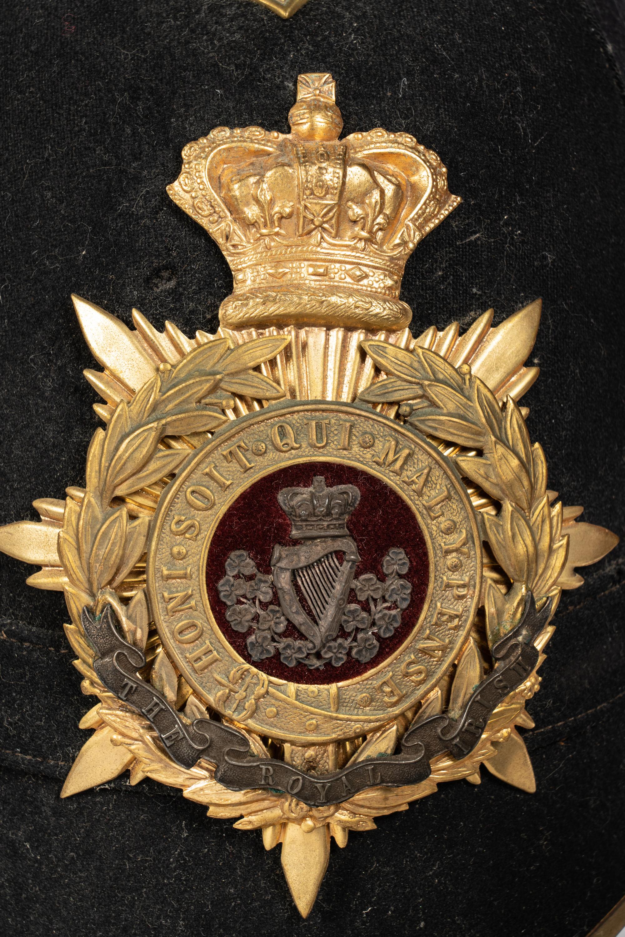 A Collection of Twenty-One Military Parade Helmets, Hats and Masks