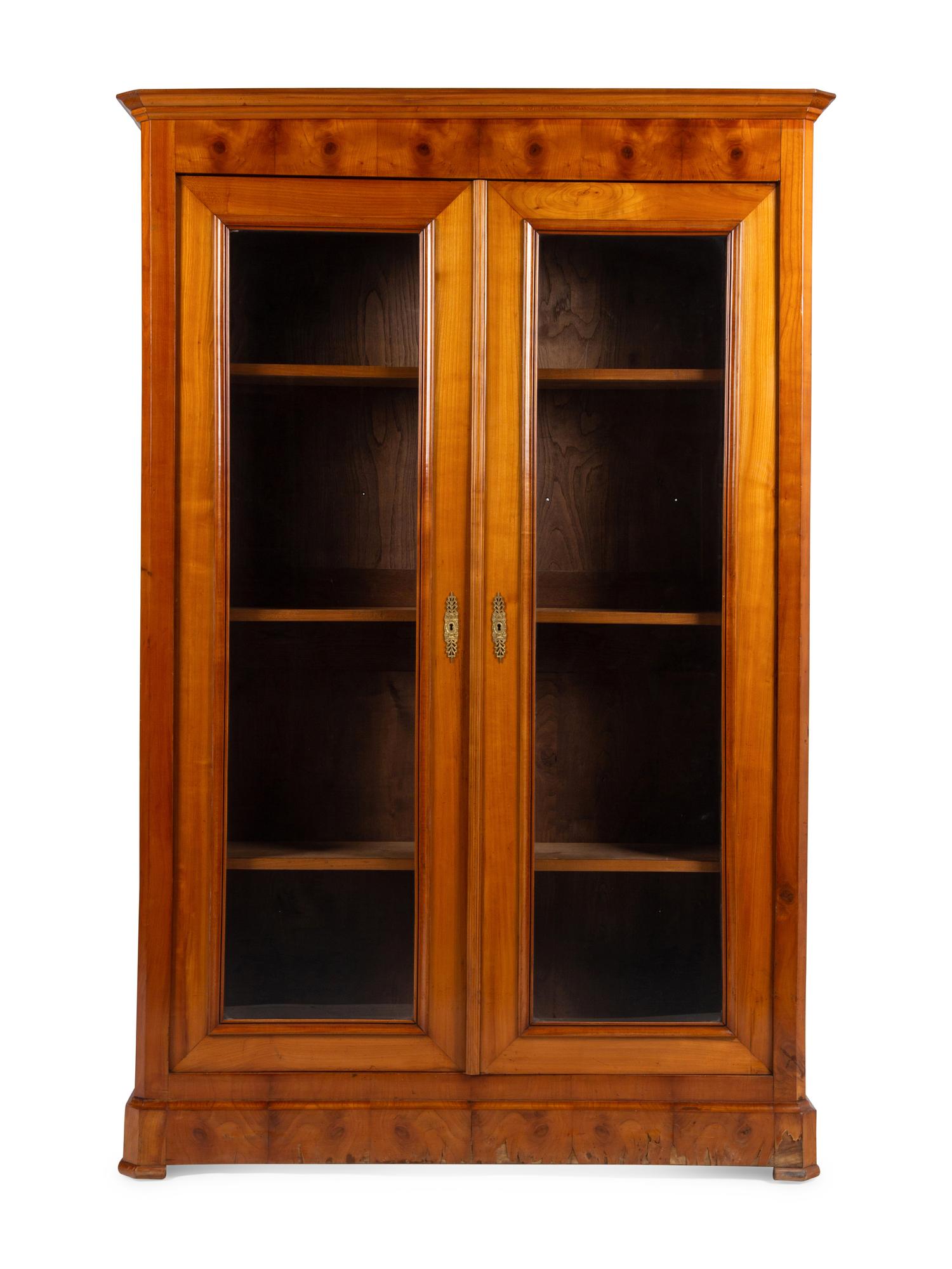 A Biedermeier Figured Walnut Two-Door Bookcase