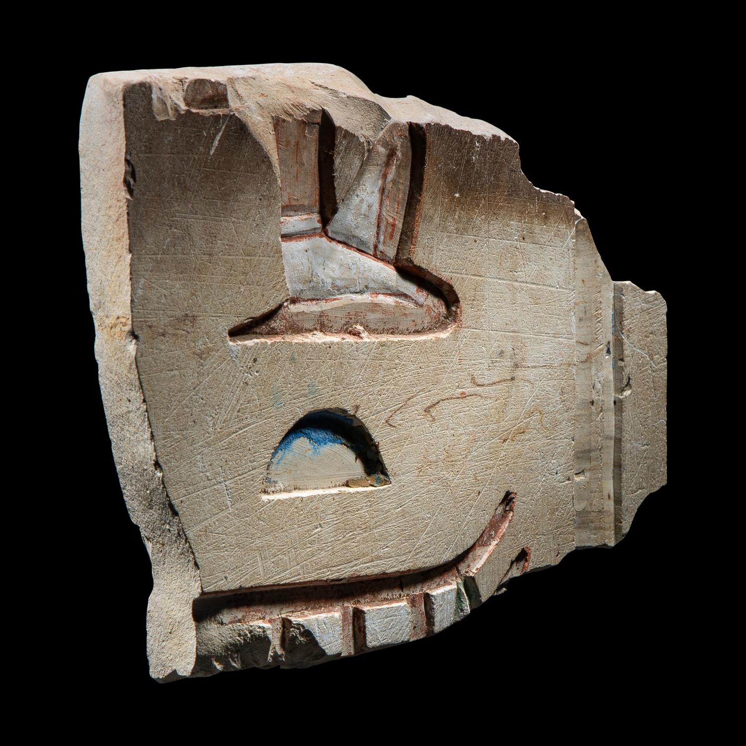 An Egyptian Painted Limestone Relief Fragment