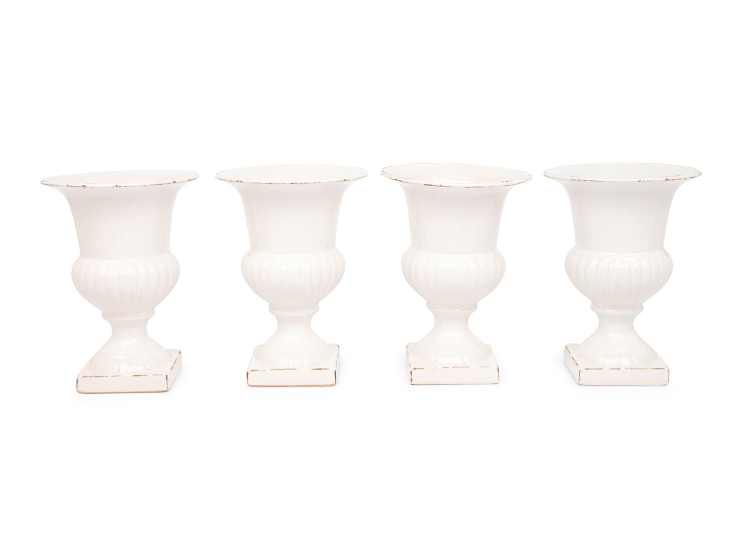 A Set of Four White Glazed Faience Urns