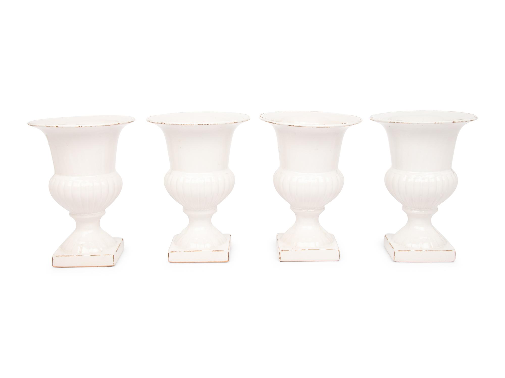 A Set of Four White Glazed Faience Urns