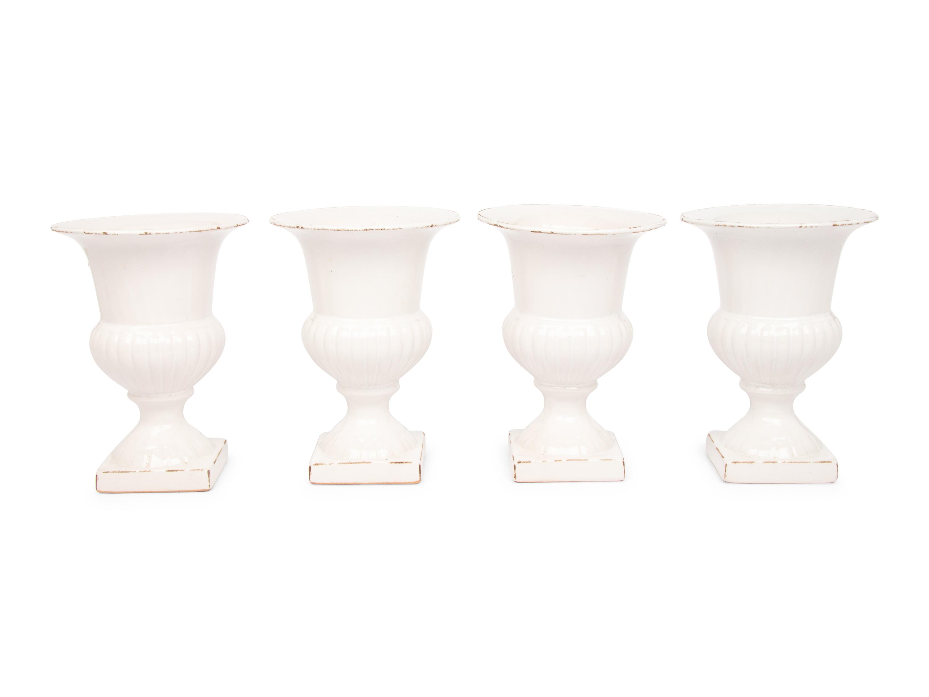 A Set of Four White Glazed Faience Urns