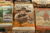 A Collection of Fifteen Tobacco Cartons and a Tobacco Rope in Display Case
