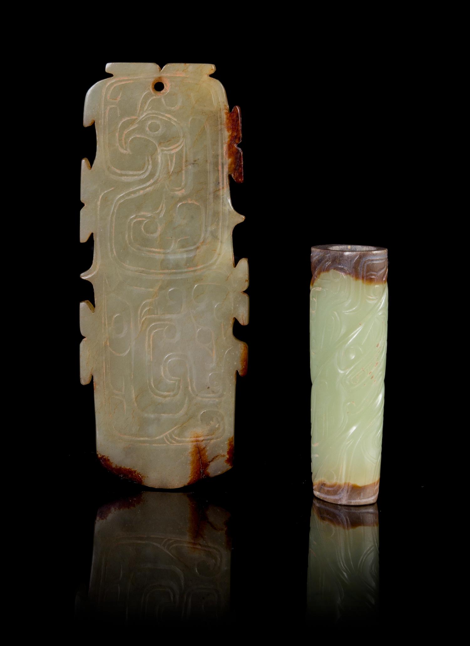 Two Celadon and Russet Jade Pendants Length of largest 3 1/4 inches.