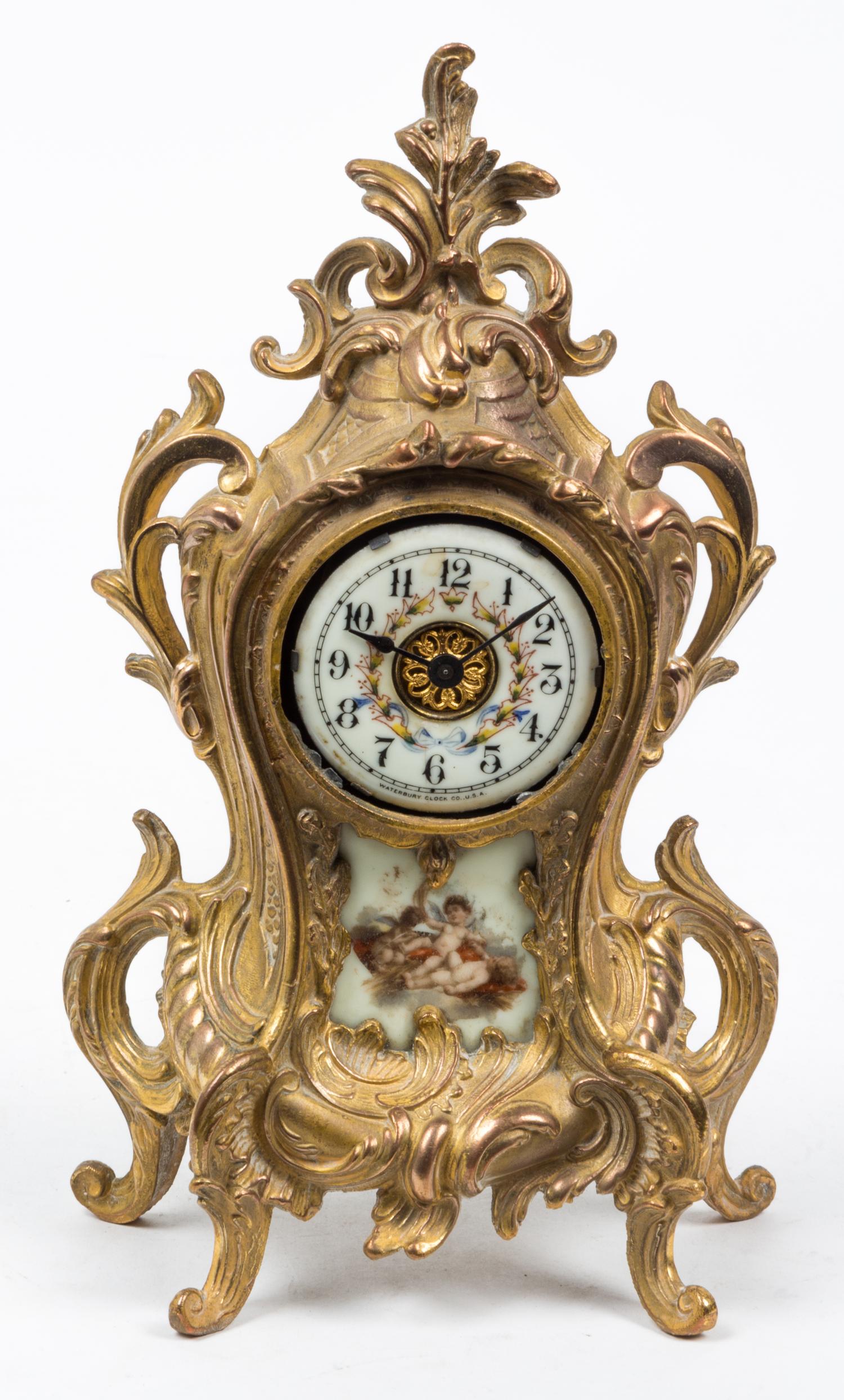 A Louis XVI Style Porcelain Inset Mantel Clock Height 11 1/4 inches. — WATERBURY CLOCK CO., EARLY 20TH CENTURY