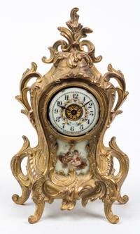 A Louis XVI Style Porcelain Inset Mantel Clock Height 11 1/4 inches. — WATERBURY CLOCK CO., EARLY 20TH CENTURY