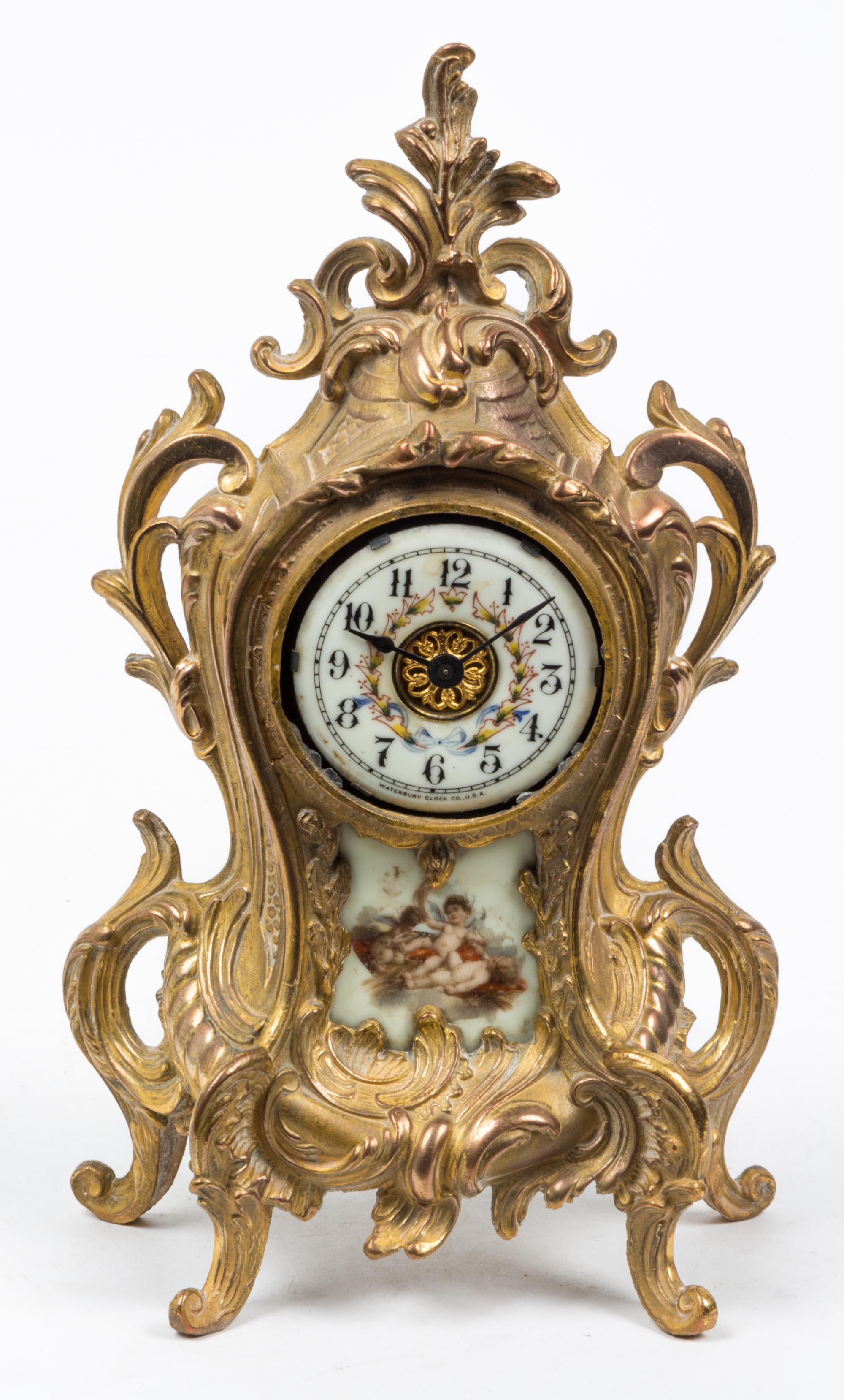 A Louis XVI Style Porcelain Inset Mantel Clock Height 11 1/4 inches. — WATERBURY CLOCK CO., EARLY 20TH CENTURY