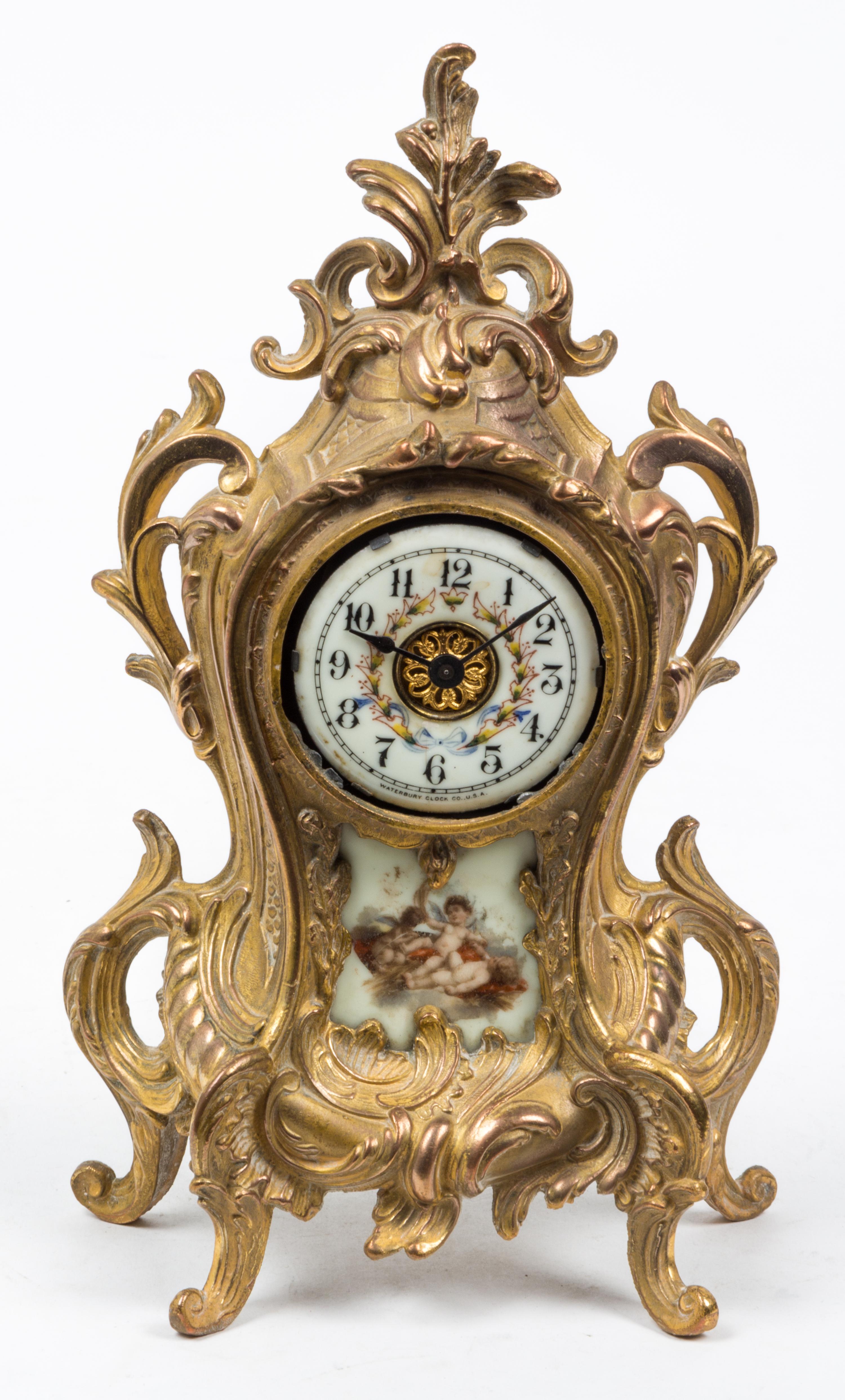 A Louis XVI Style Porcelain Inset Mantel Clock Height 11 1/4 inches. — WATERBURY CLOCK CO., EARLY 20TH CENTURY