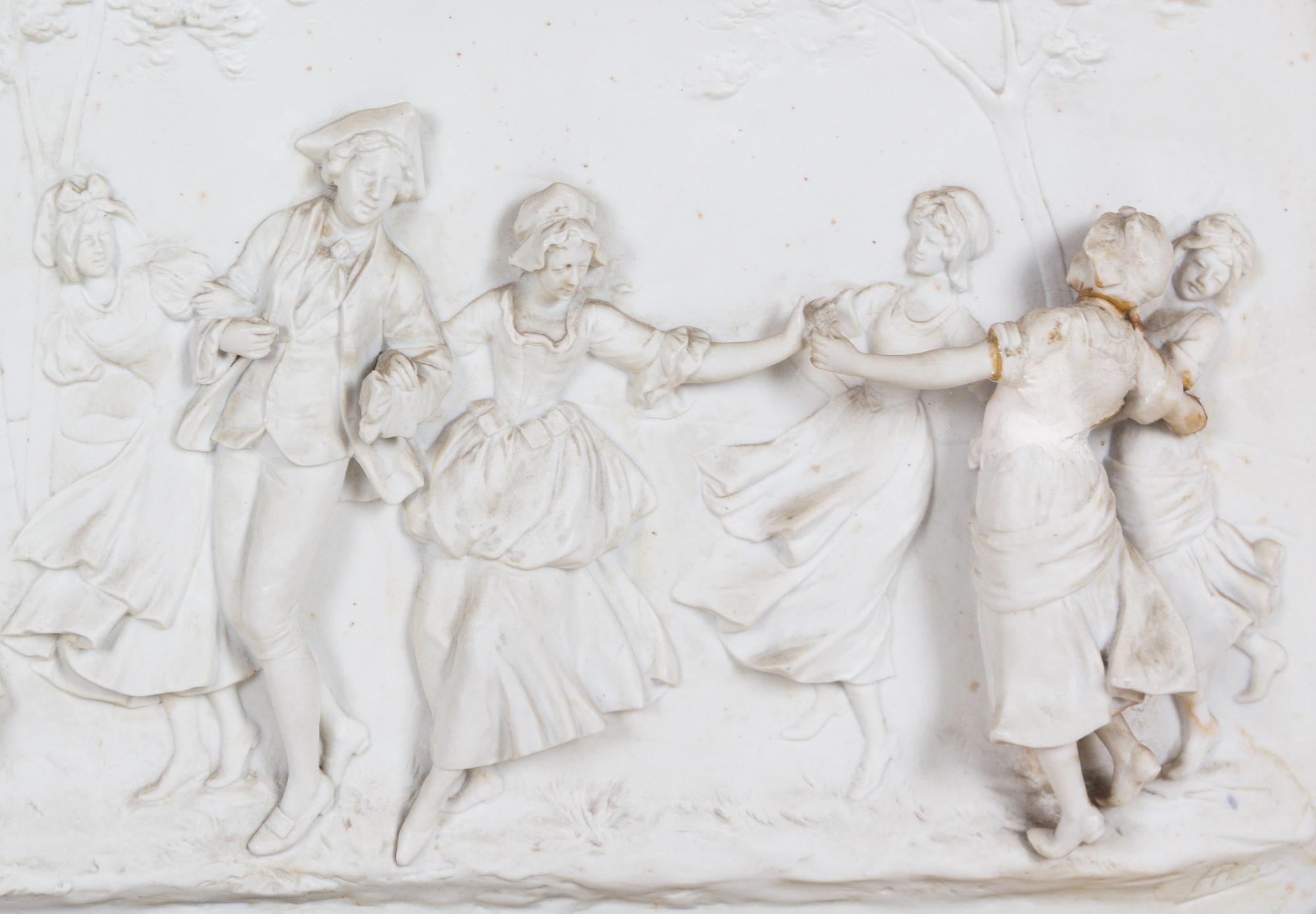 A Painted and Parcel Gilt Mirror with an Inset Bisque Porcelain Plaque