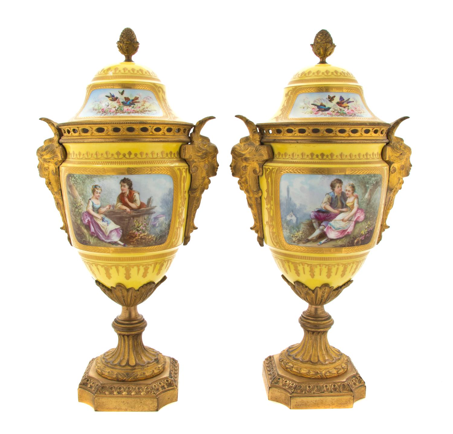 A Pair of Sevres Style Porcelain and Gilt Metal Mounted Covered Urns, Height 13 inches.