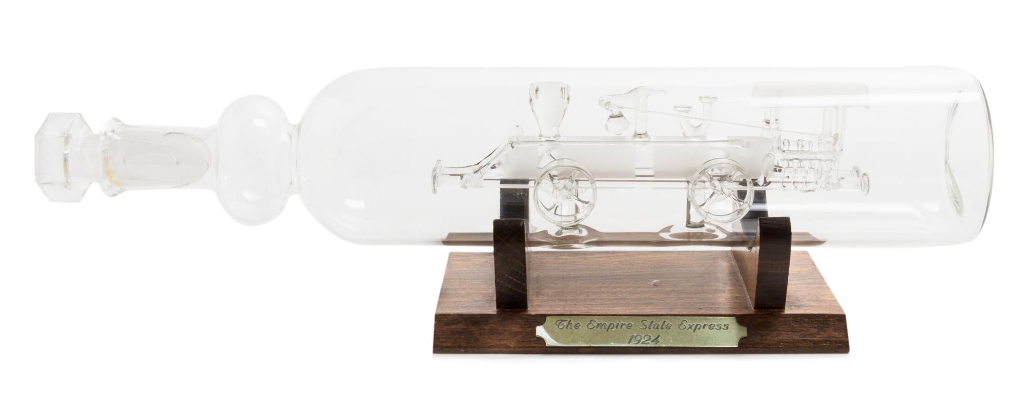 A Spanish Blown Glass Model of a Locomotive in a Bottle Width 11 3/4 inches. — CIRCA 1920s